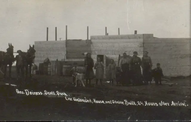 Deiness family outside their newly built house and stable, Scott
